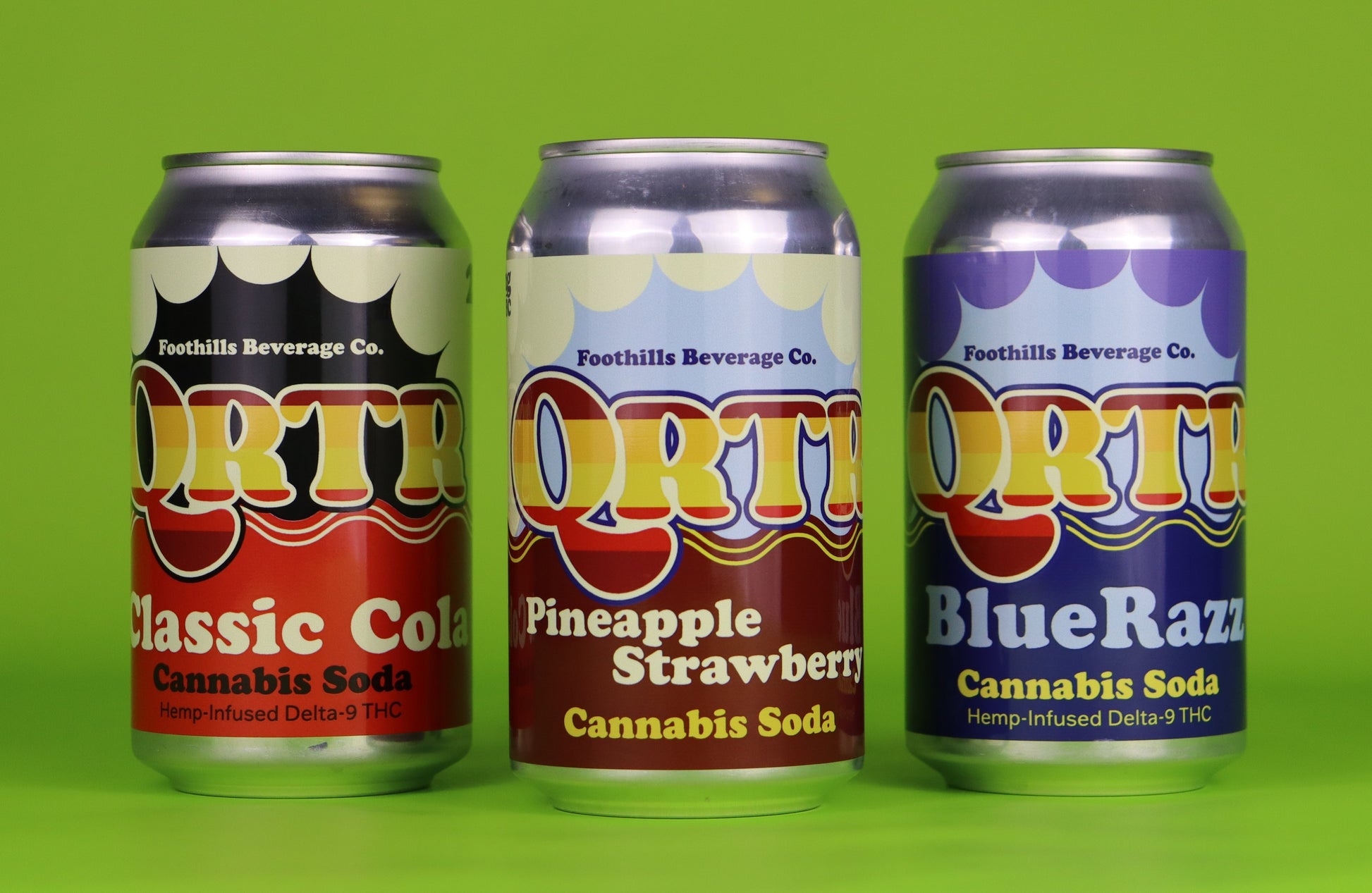 Three cans of QRTR cannabis soda on a green background